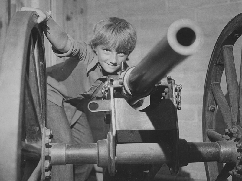 Brent Hammond of Tooele poses with a cannon in the Gun Collection, 1976. Photo courtesy of Deseret News