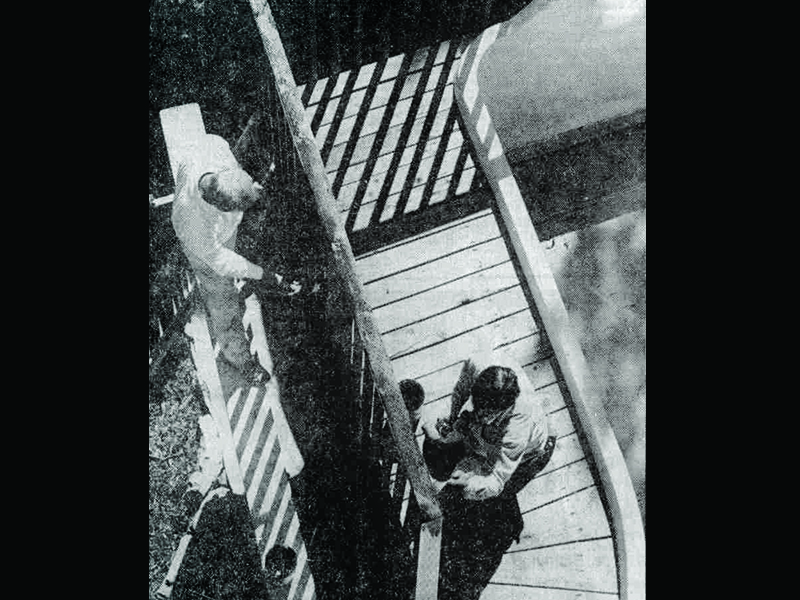 Brad Harris and Don Edwards apply wood preservative along the outrigger in May 1990. Photo: Robert Regan, Standard-Examiner