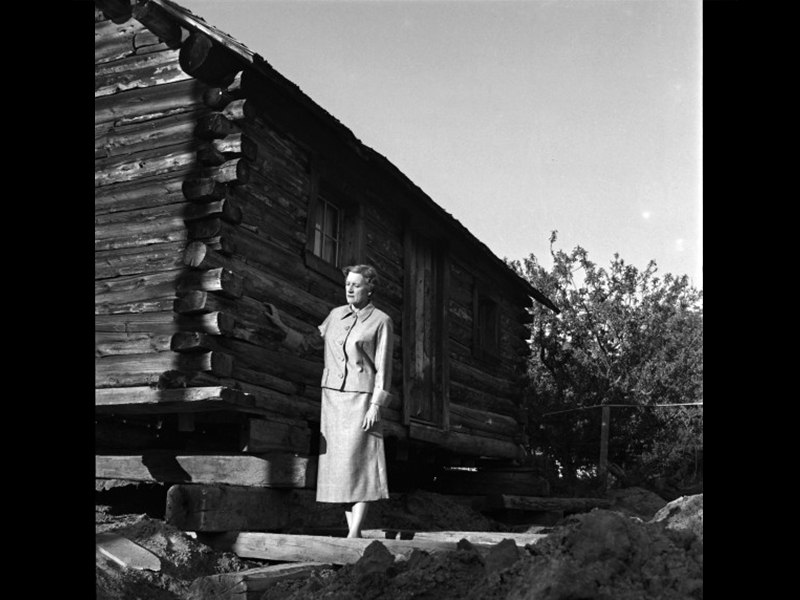 Ethel Sorenson with the Bingham Cabin after its arrival at Pioneer Village in Salt Lake City. Photo: The Salt Lake Tribune