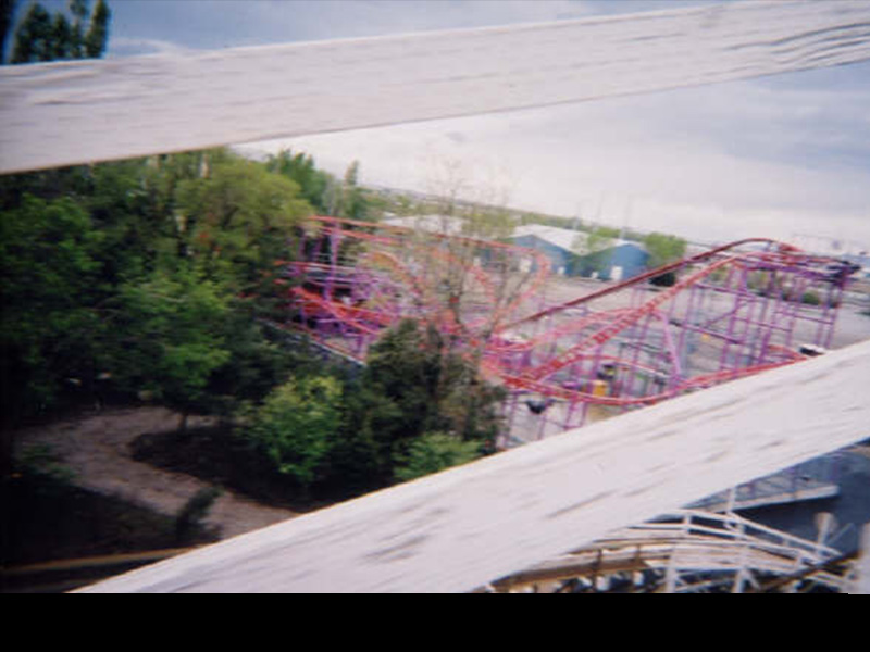 View of The Spider from the Roller Coaster in 2004. Evidence of part of the former Speedway, Sr. ride path is still visible on the left. Photo: Mike P.