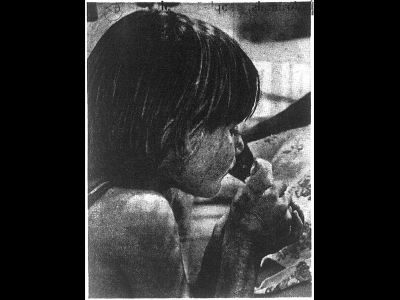 "Jeff Kidkiff, 7, takes a peek at a baby chick," 1977. Photo: Deseret News