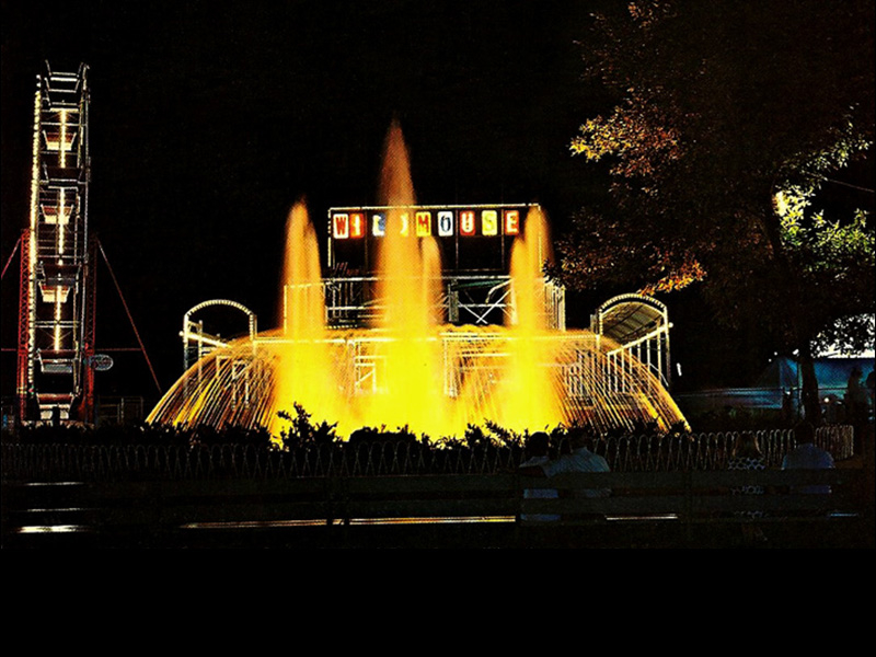 Postcard of the North Midway at night in the 1960s. Ferris Wheel, Wild Mouse and part of Space Scrambler are shown beyond the Bamberger Fountain.