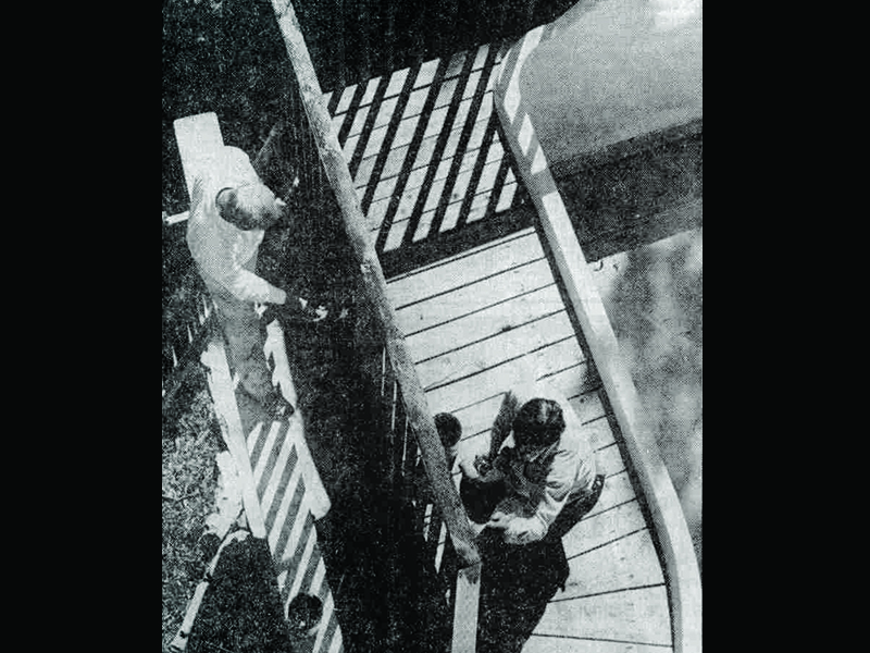 Brad Harris and Don Edwards apply wood preservative along the outrigger in May 1990. Photo: Robert Regan, Standard-Examiner