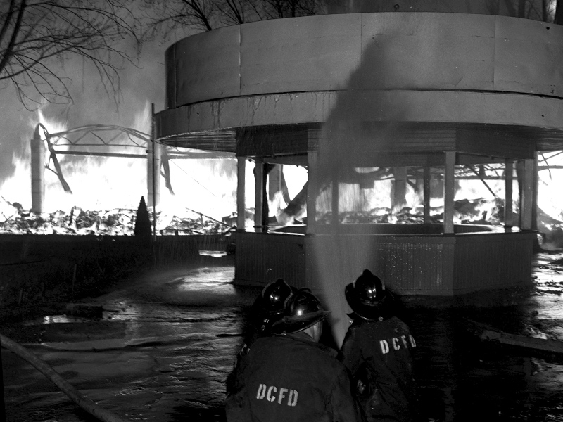Firefighters douse a building in water to help keep the fire from spreading. Photo: The Salt Lake Tribune