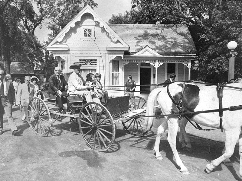 Spencer W. Kimball passes the Gingerbread House on his way to dedicate Pioneer Village in May 1976. Photo courtesy of Deseret News